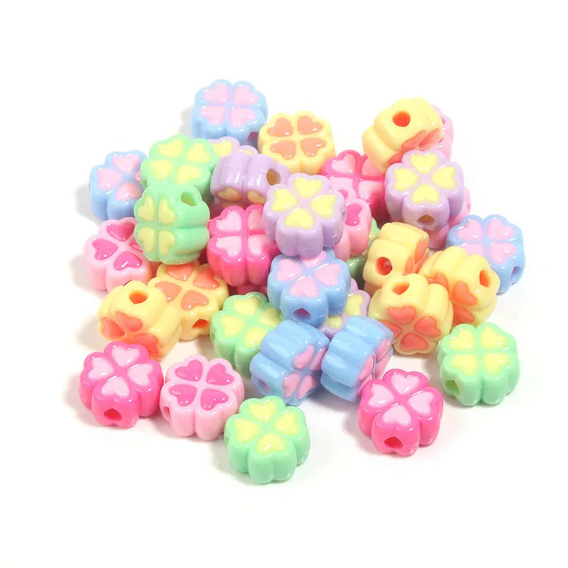 Acrylic four-leaf clover craft beads with love pattern in mixed colours showing frosted finish
