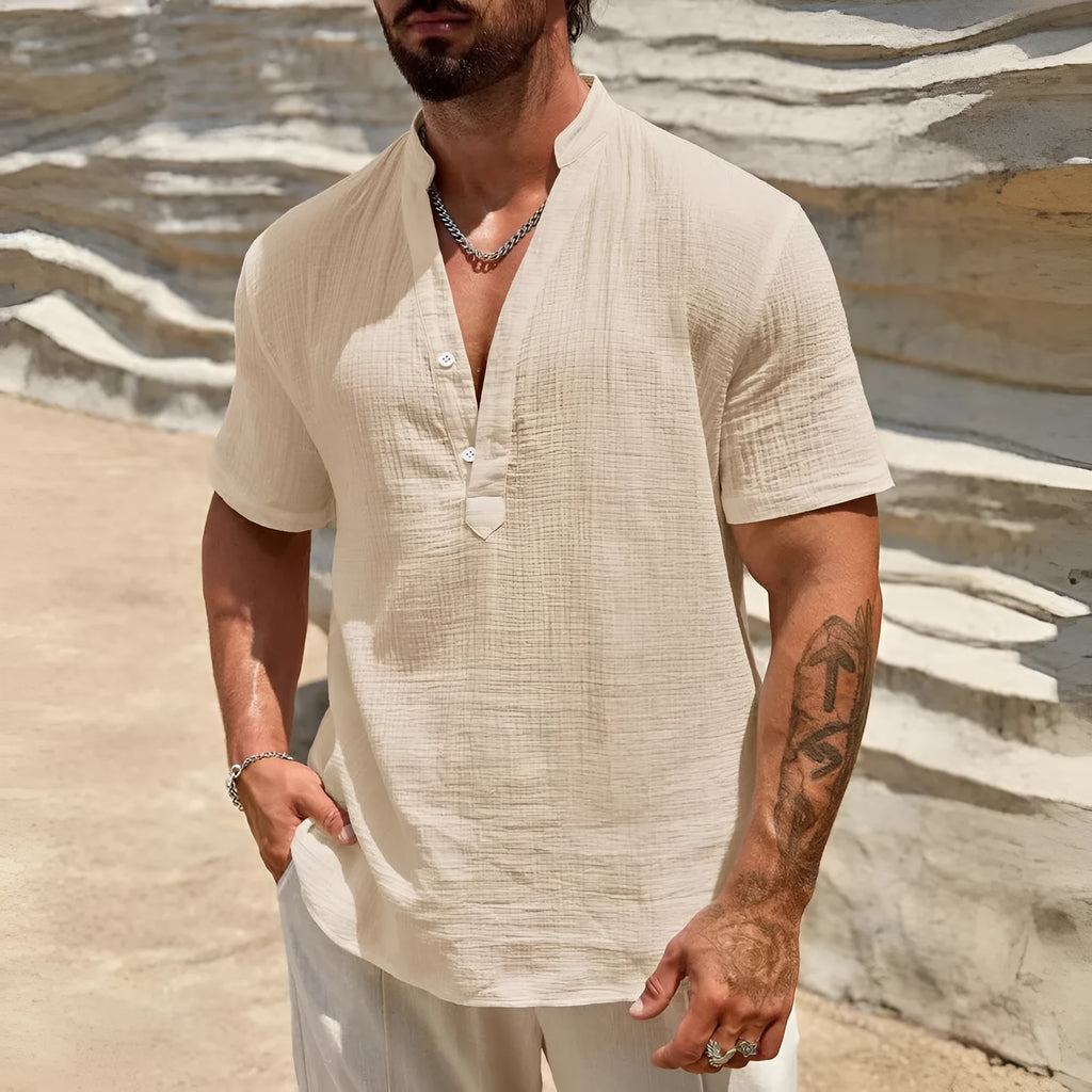Men's solid colour short-sleeved shirt with stand collar in light blue, laid flat.