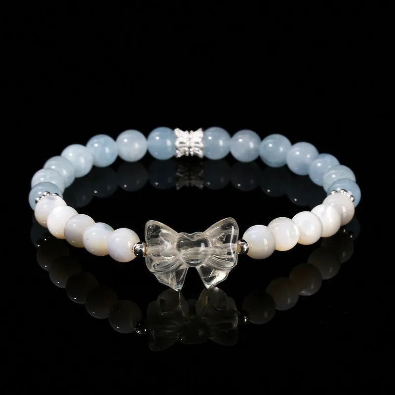 Natural star pink crystal cat head bracelet on a woman's wrist