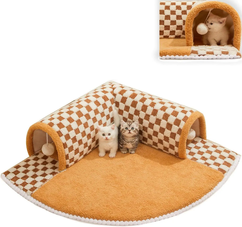 Brown plaid plush cat tunnel bed with a central mat on a wooden floor.