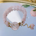 Crystal safety buckle bracelet for women in pink with peace buckle design on white background