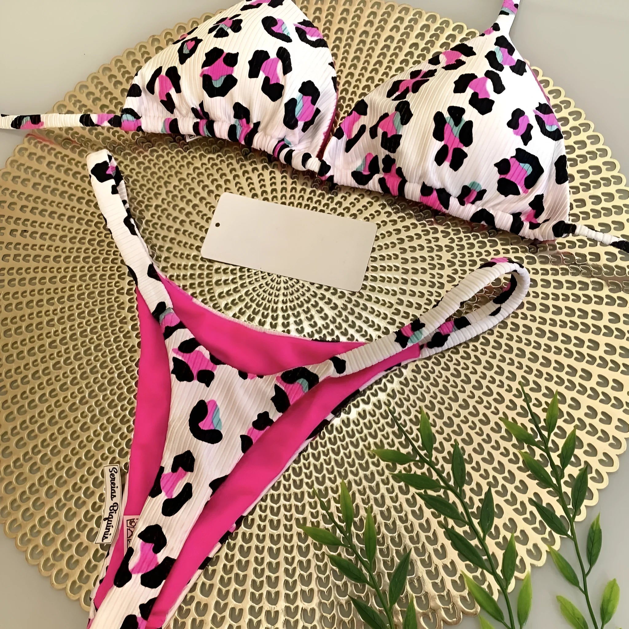 Women's printed bikini swimsuit set with quick-dry fabric on a mannequin, showing briefs style.
