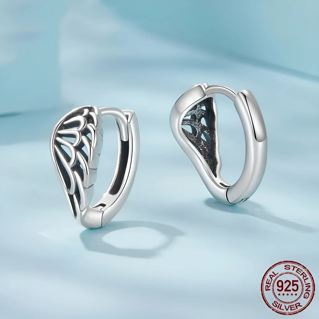 Pair of vintage S925 sterling silver wings ear clip earrings in silver colour on white background