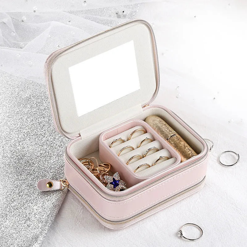 Small PU zipper jewellery box in light blue with fabric lining, 11.5x8.5x5cm, open to show rings and earrings