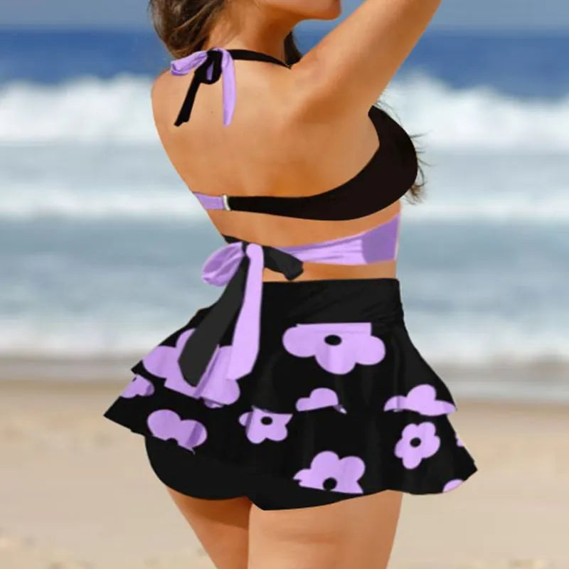 Women's black lace-up bikini with a matching high-waisted split skirt.