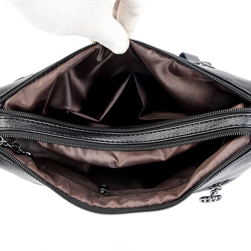 Genuine leather horizontal square messenger bag with contrasting stitching and single shoulder strap in black