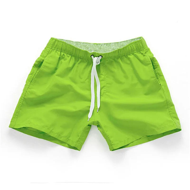 Men's straight-leg beach shorts in black polyester fabric on a size chart.