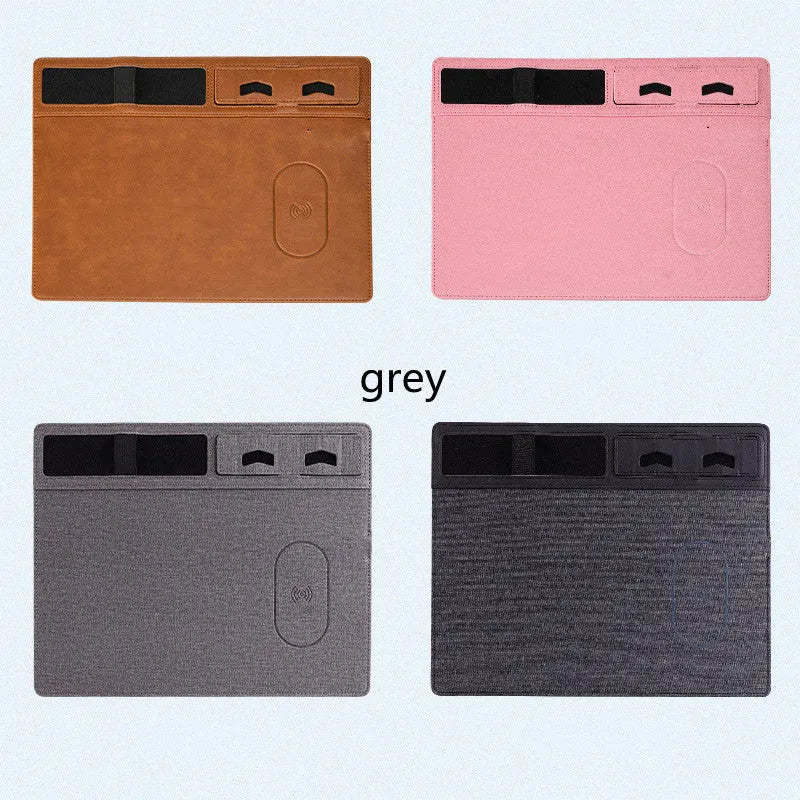Pink wireless charging mouse pad with integrated mobile phone holder on a desk.