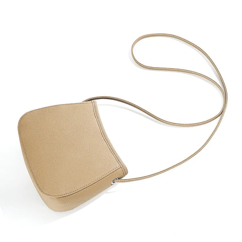 Women's genuine cowhide messenger bag in beige with soft surface leather, square vertical shape, and removable handle