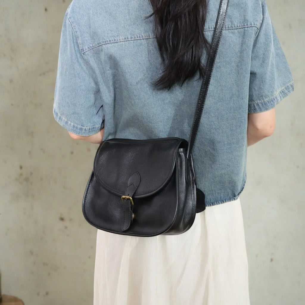 Genuine leather messenger bag with shell shape and sewing line detail in brown