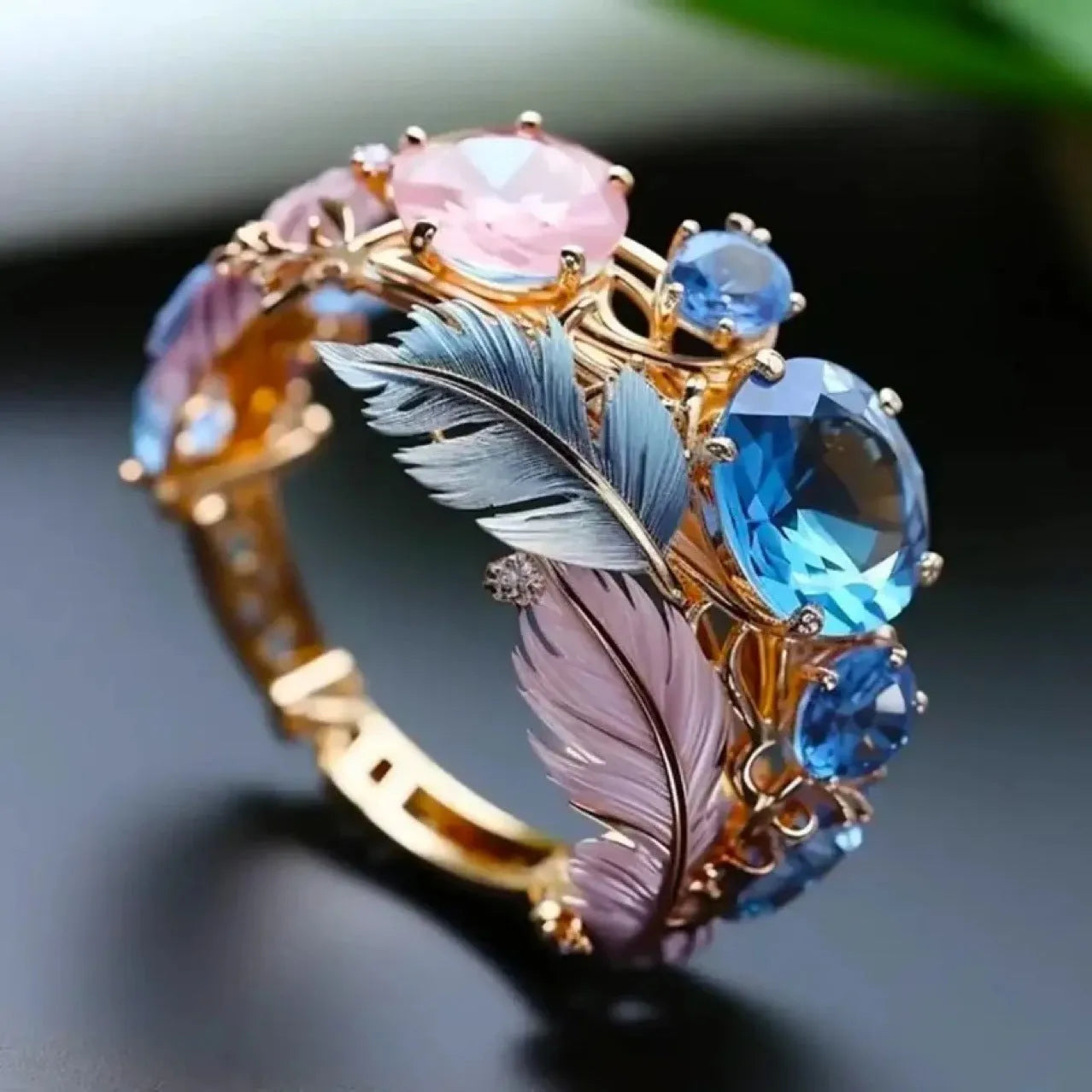 Gold geometric brass ring with an embossed colourful feather design and zircon stone accents.