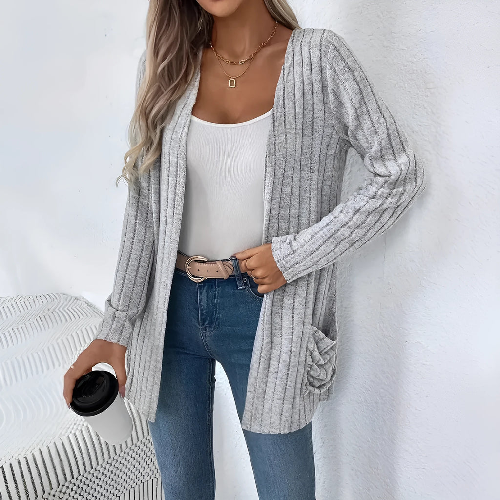 Man wearing a solid grey loose-fit long sleeve cardigan with side pockets.