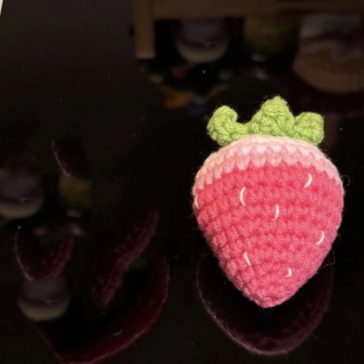 Plush strawberry pendant keychain in pink with metal ring on a white background