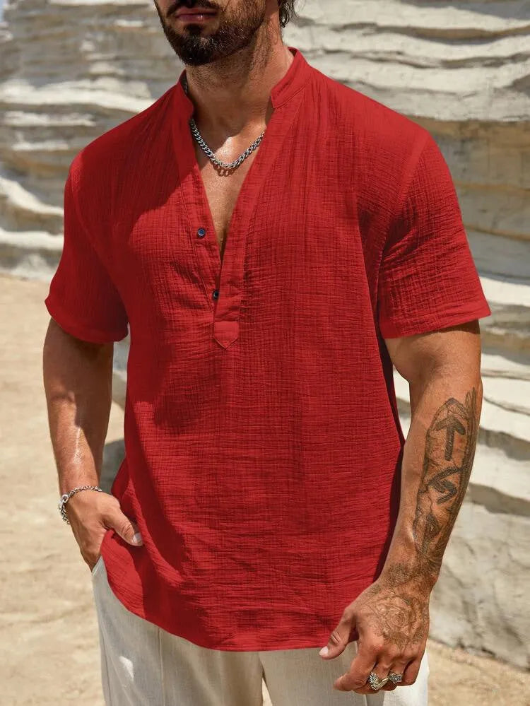 Men's solid colour short-sleeved shirt with stand collar in light blue, laid flat.