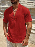 Men's solid colour short-sleeved shirt with stand collar in light blue, laid flat.
