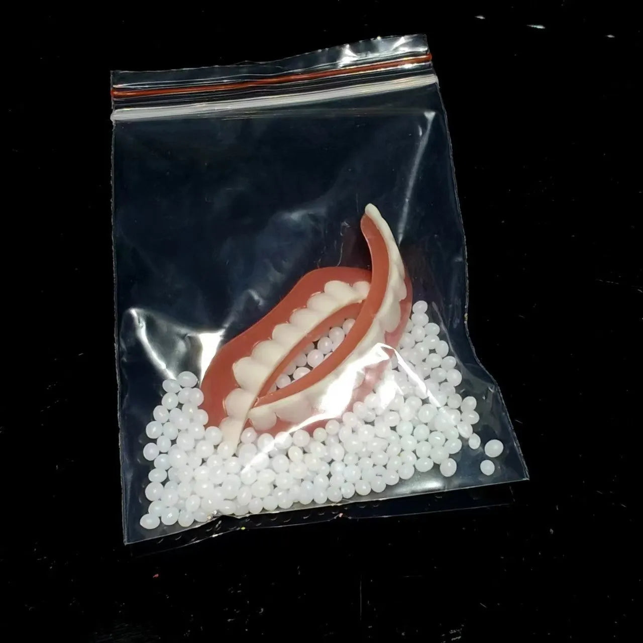 Silicone dental training dentures model showing upper and lower teeth simulation in tooth socket