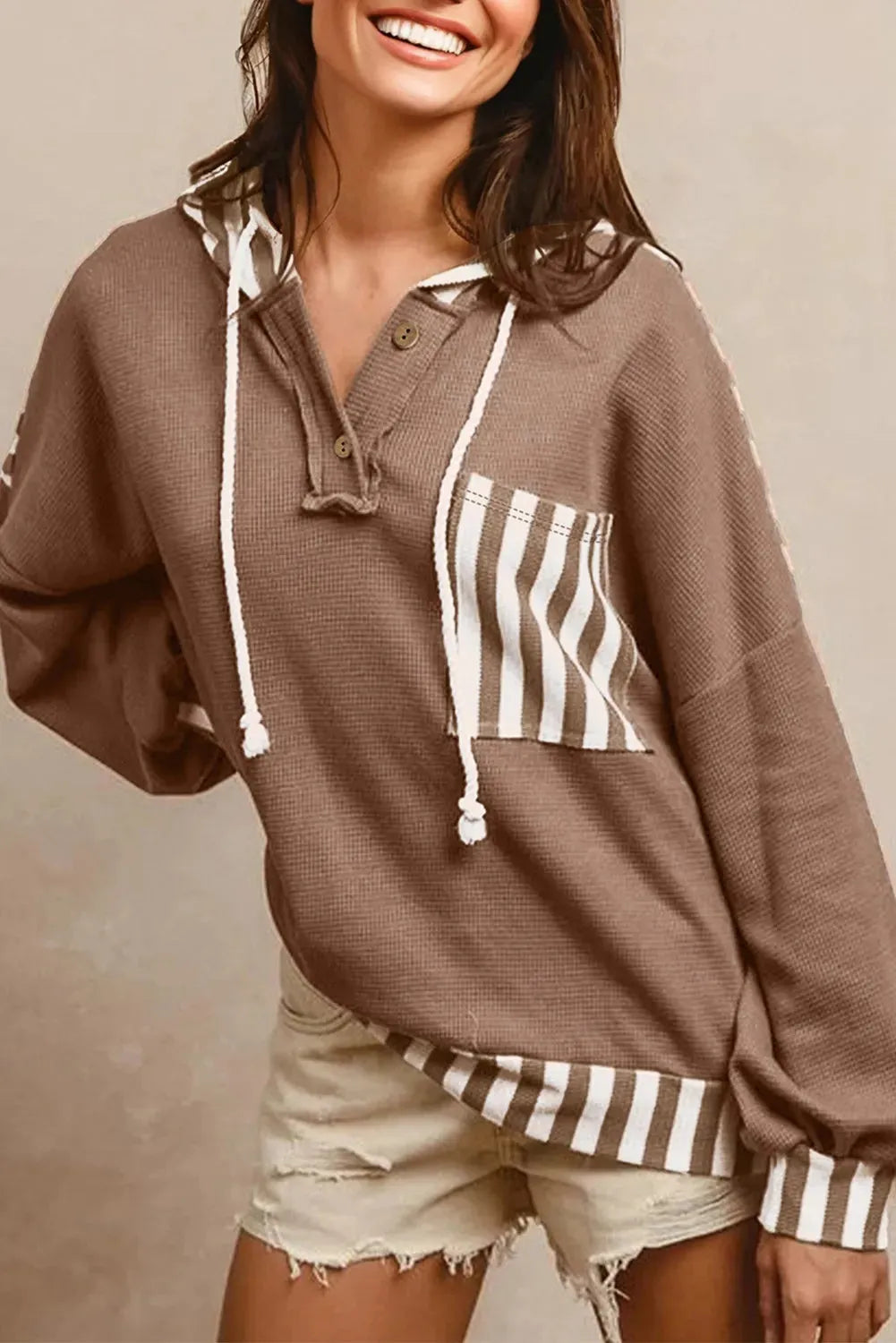 Straw yellow waffle texture hoodie with striped patchwork panels and button neck closure