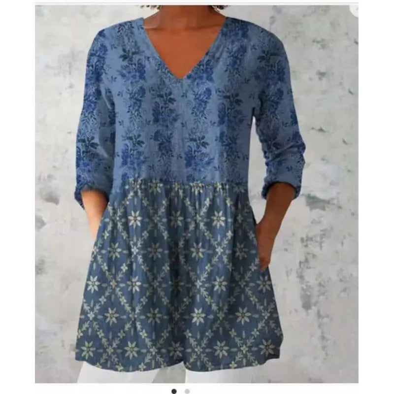 Women's printed loose dress with wide waist and 3/4 length sleeves on a hanger.