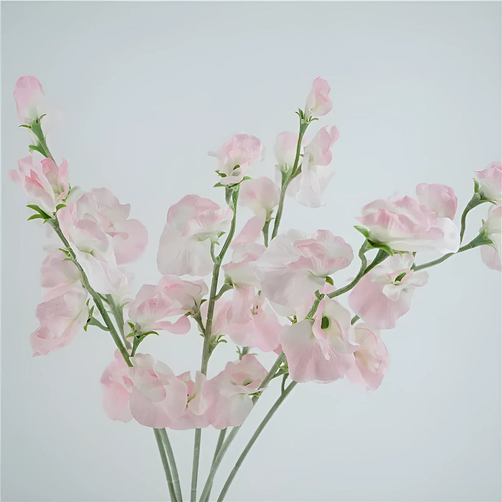 Silk artificial pea flower single stem in pink with green wire stem on white background