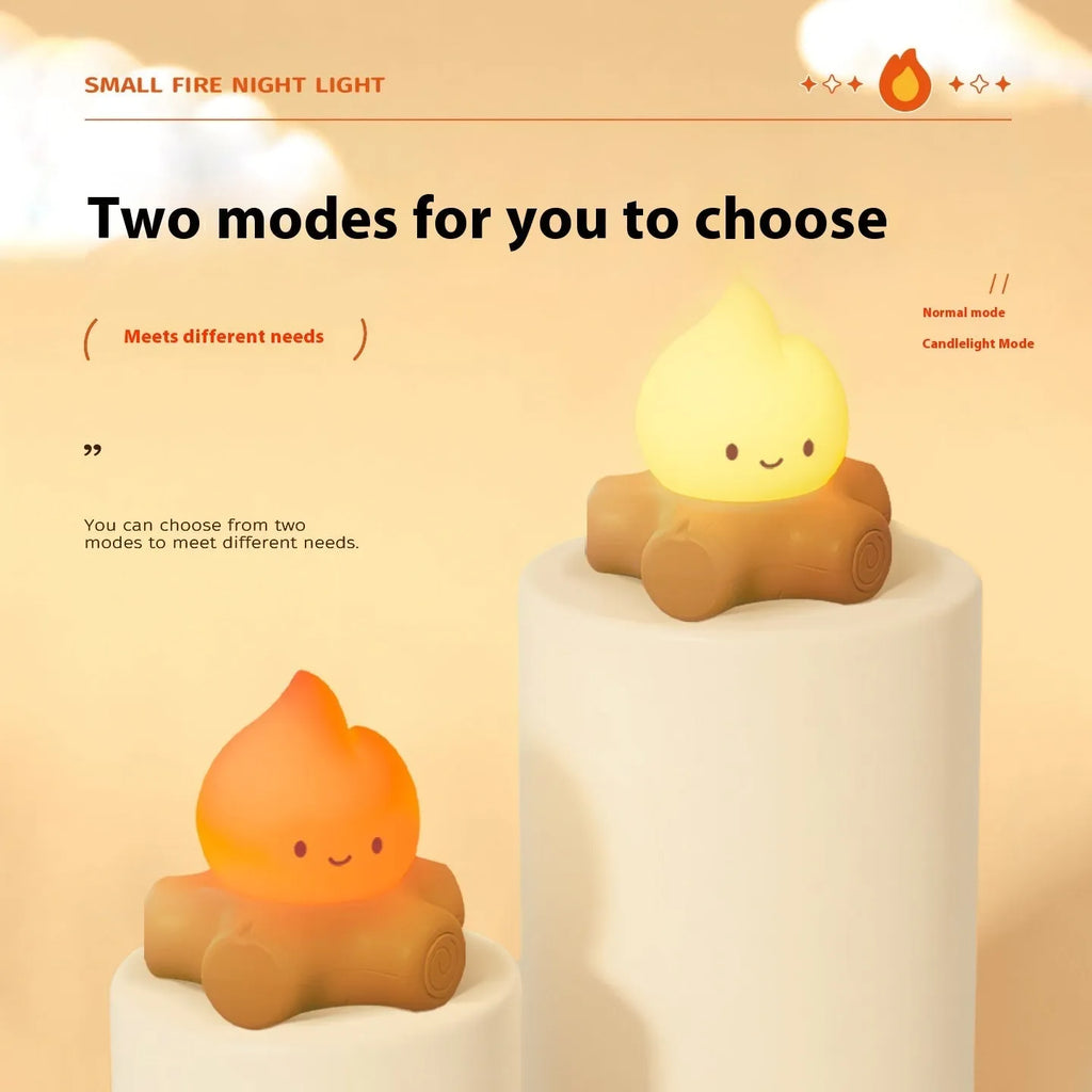 Cartoon-style silicone small fire pile night lamp with yellow glow on a table