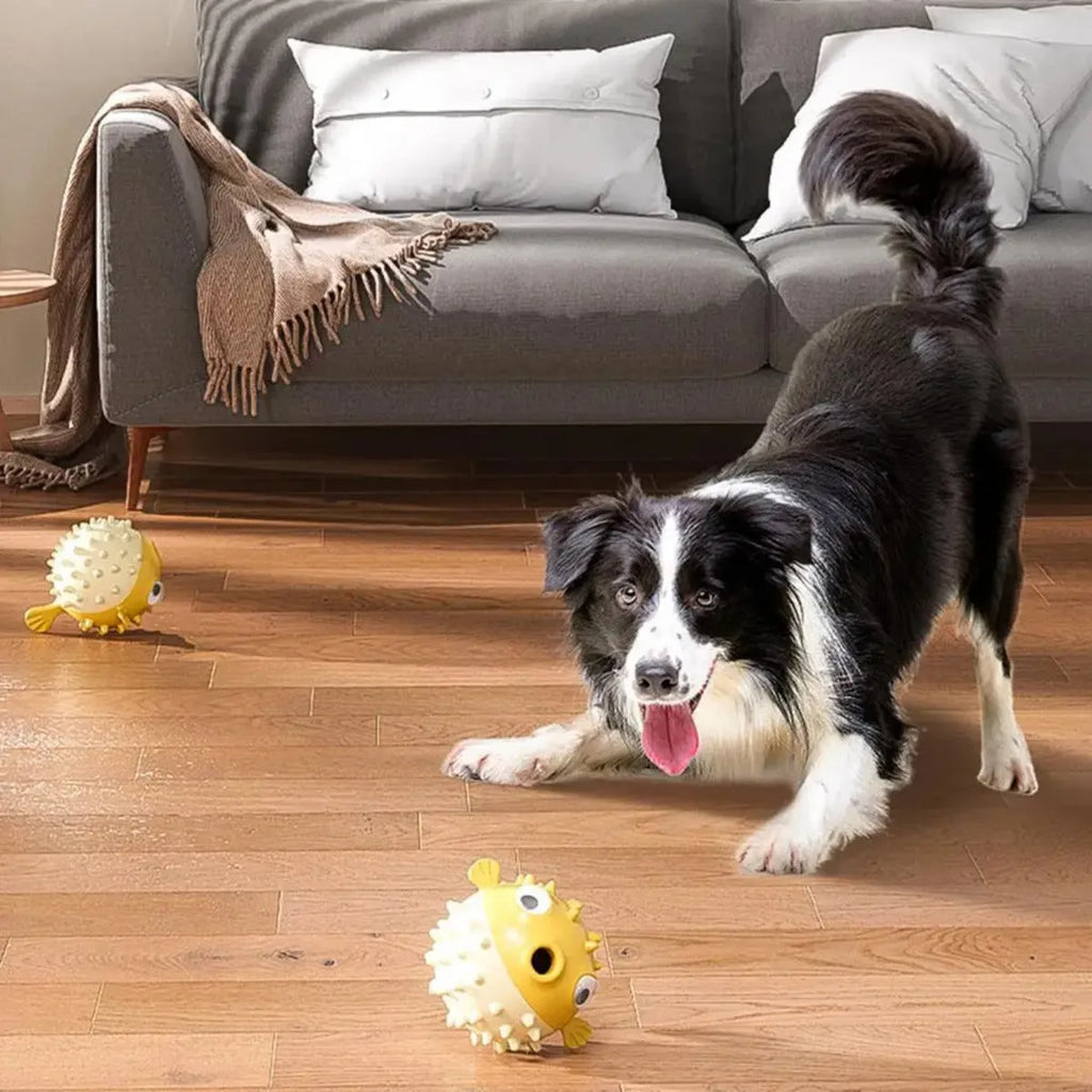 Yellow fish-shaped vinyl dog chew toy with textured surface and squeaker inside.