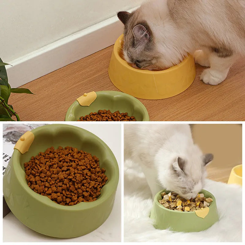 Green and yellow plastic double pet bowl for food and water on a flat surface.