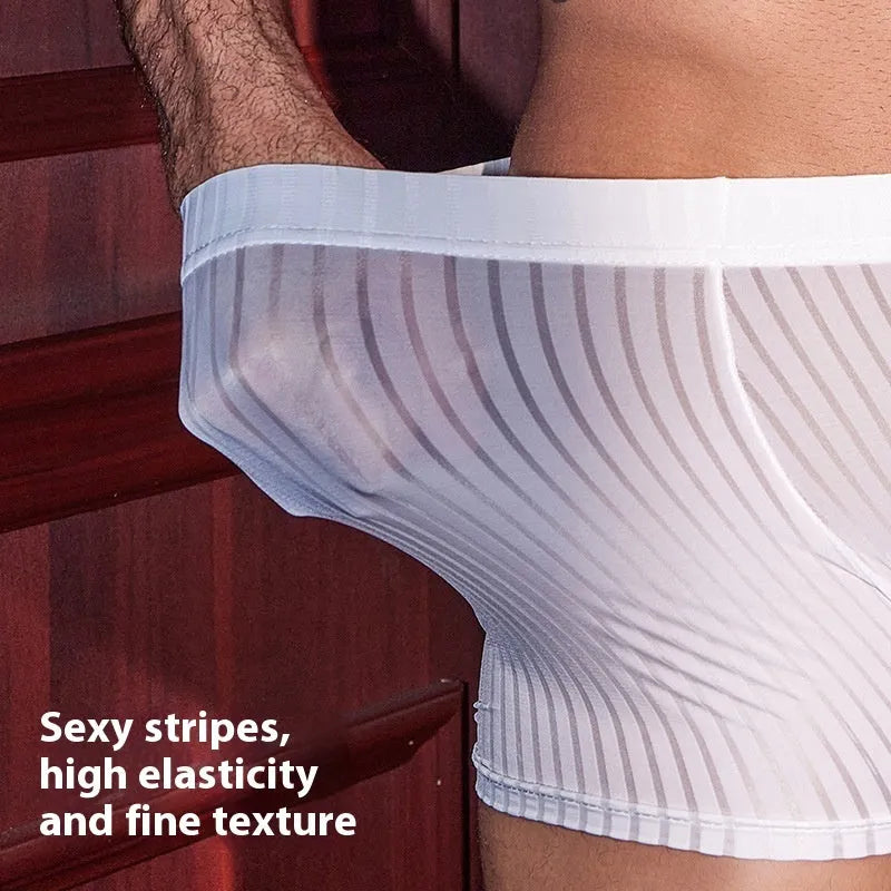Man wearing black striped nylon boxer briefs, showing high elastic fit and modern design.