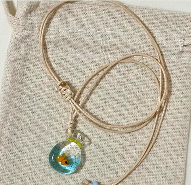 Women's necklace with a coloured glaze Joker pendant wearing a skirt on a cotton and linen chain.