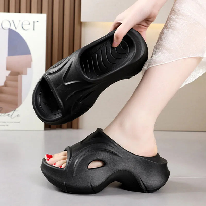 Women's thick-soled EVA slippers in rose red, white and black colours on a beach background.