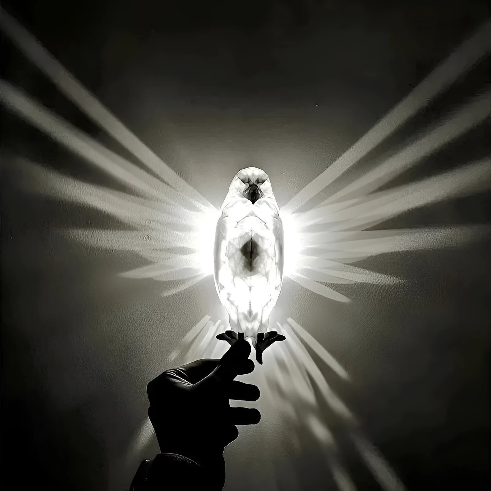 Eagle-shaped resin wall lamp with 3D print body projecting light and shadow on a wall