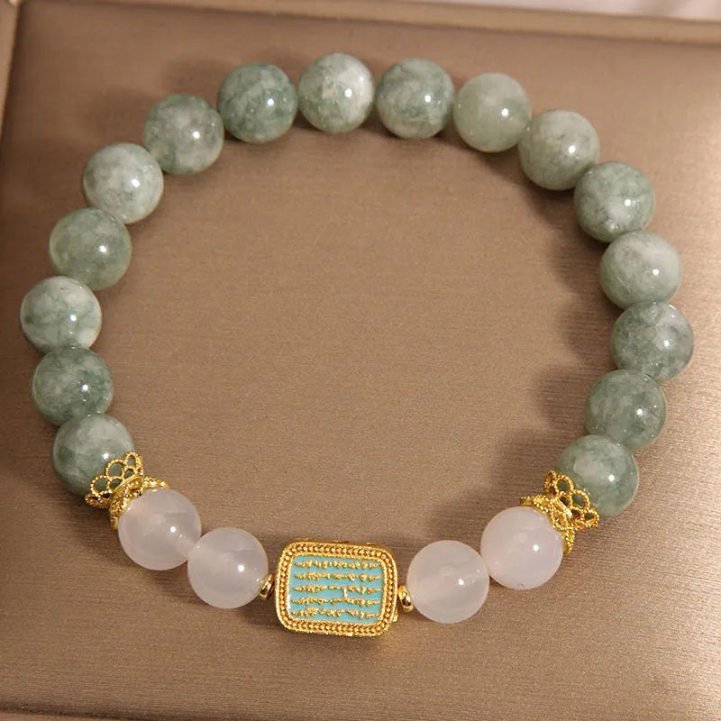 Oil green emerald crystal bracelet with five faceted beads on a string for women.