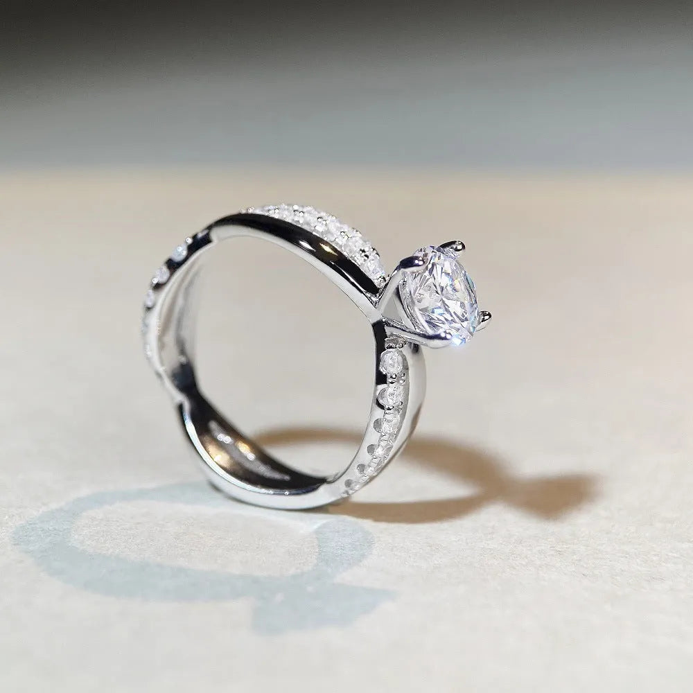 Silver moissanite ring with 1 karat stone and cross twisted arm geometric design