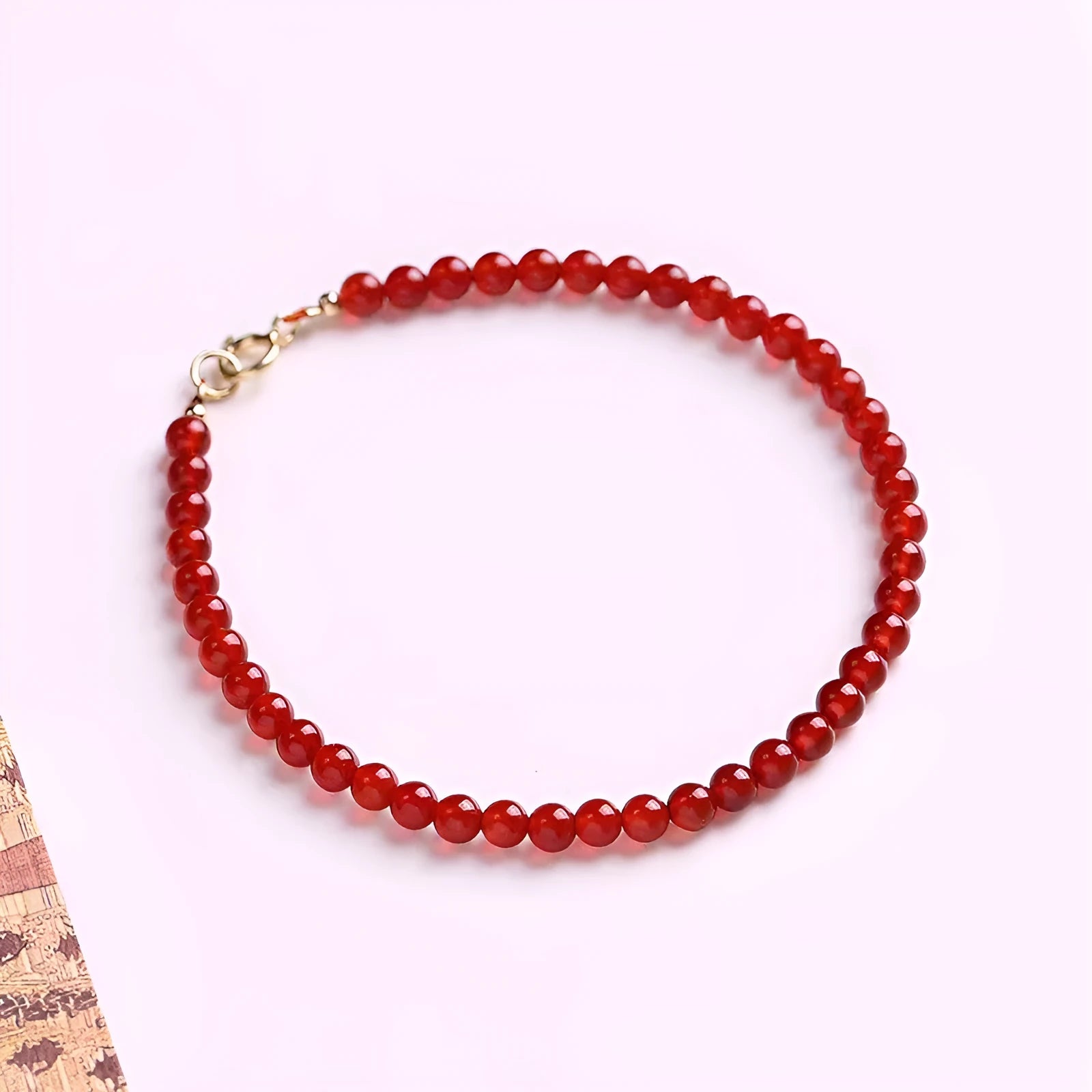Ultra-thin red agate calm small bracelet for women classic style on neutral background