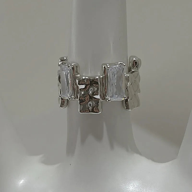 Silver geometric cross ring with zircon detail and open retro design