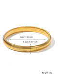Gold titanium steel women's bracelet with elastic band and exaggerated vertical stripe ring pattern.