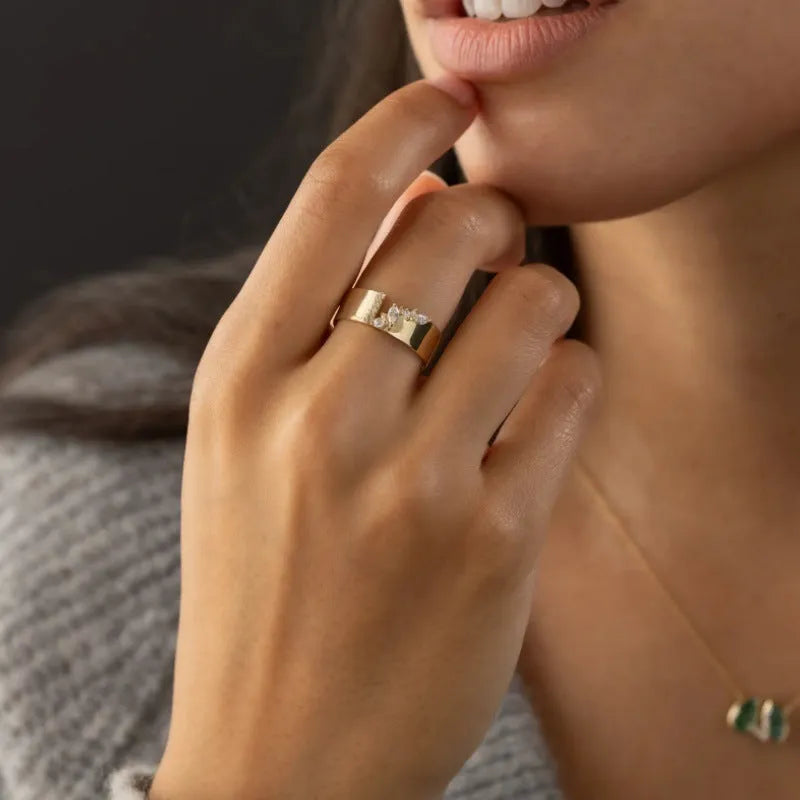 Gold-plated copper ring with shining zircon stones showing side and top views
