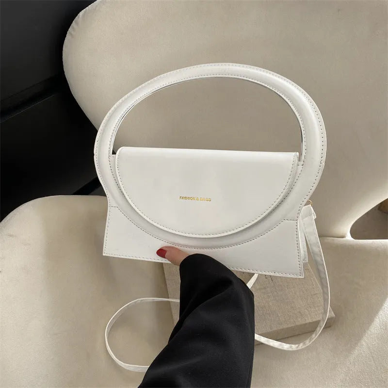 PU leather messenger bag in horizontal square shape with phone pocket and stitching details