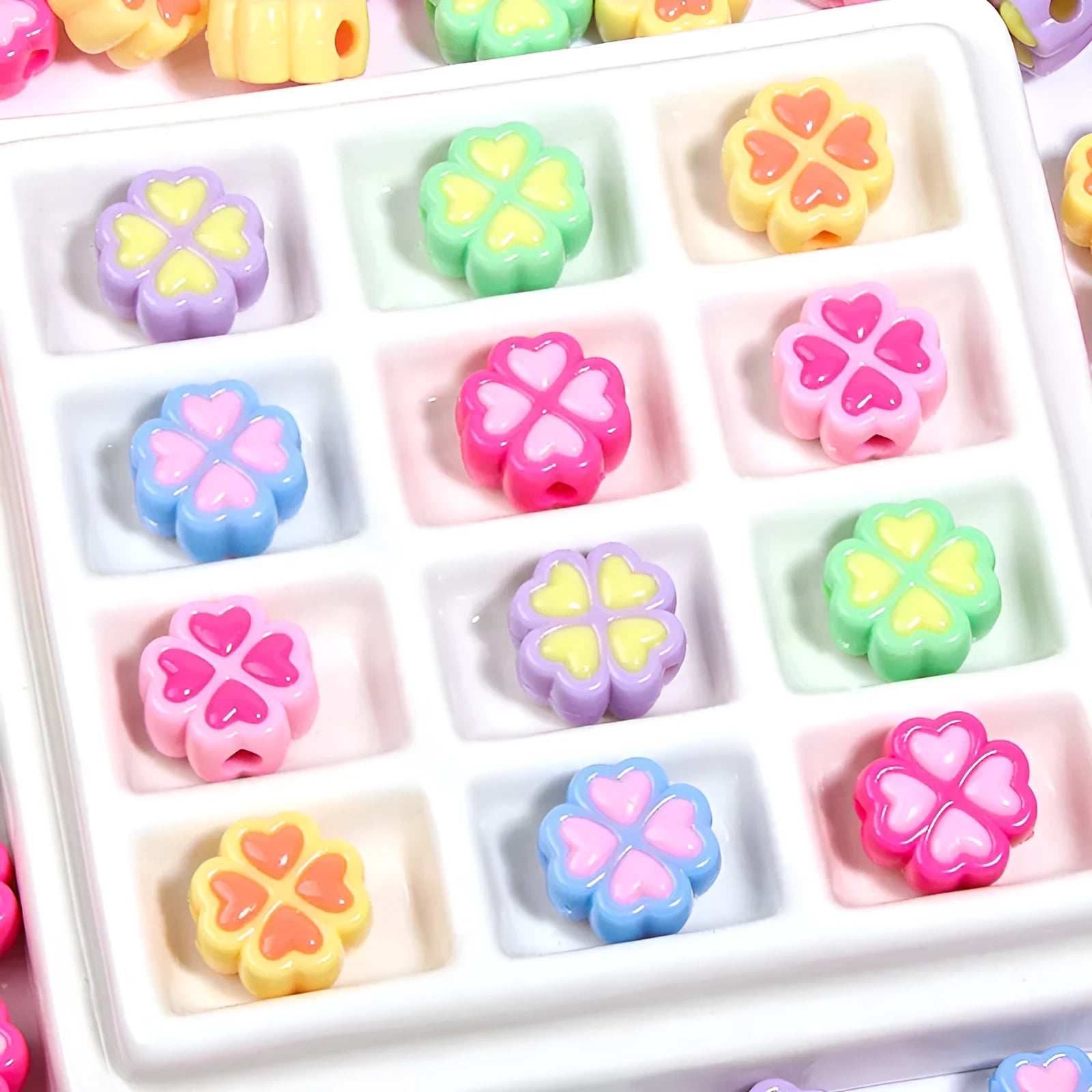 Acrylic four-leaf clover craft beads with love pattern in mixed colours showing frosted finish