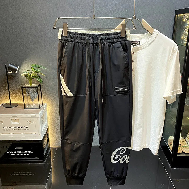 Men's black ultra-thin ice silk ankle banded cropped casual trousers on hanger