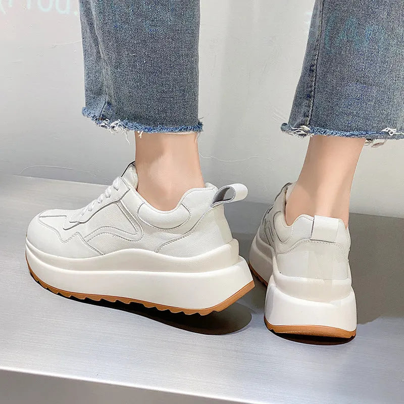 Beige women's low-top leather casual shoes with cross strap and English muffin heel on a white background.