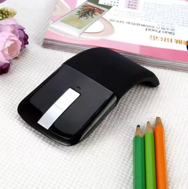 Folding wireless touch mouse shown in black colour with Bluetooth connectivity