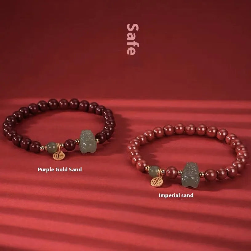Natural Hetian jade cinnabar bracelet with 8mm beads, Emperor Sandstone style, on display