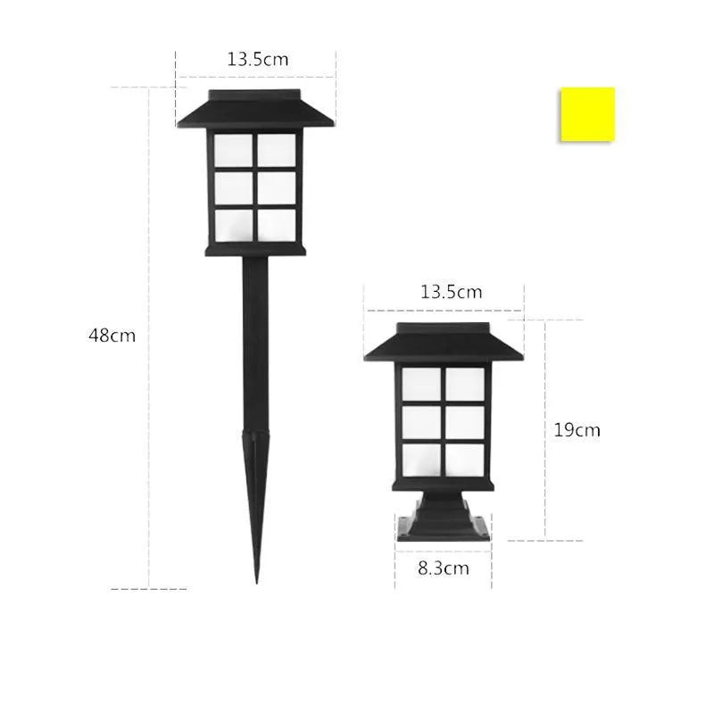 Black solar outdoor LED lawn light with decorative windows, IP65 waterproof, placed in a garden