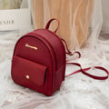 Women's small PU shoulder backpack in solid colour with convertible strap design and zipper closure