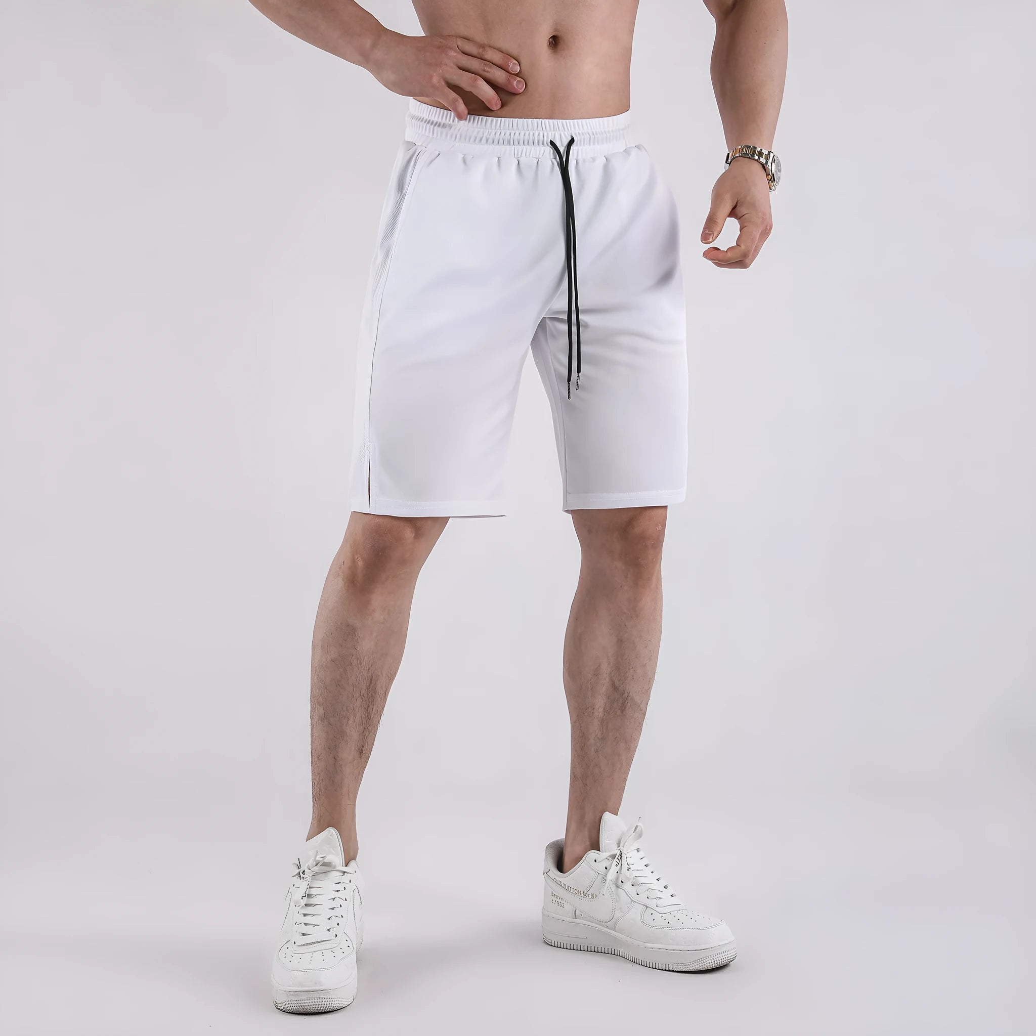 Men's black quick-dry mesh fitness shorts with elastic waistband laid flat.