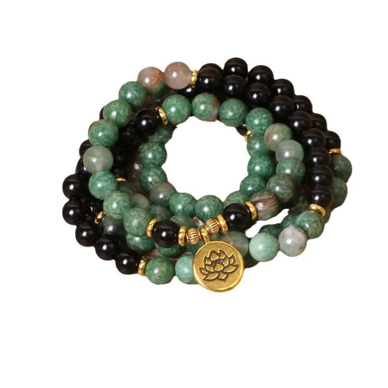 Green and black elastic beaded alloy bracelet with stretch design on wrist