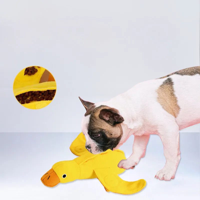 Yellow plush teddy duck dog toy with sound mechanism and treat leak hole for pet training