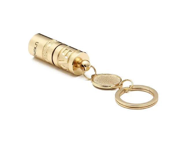 Gold-coloured zinc alloy waterproof mini LED keychain flashlight on a keyring.