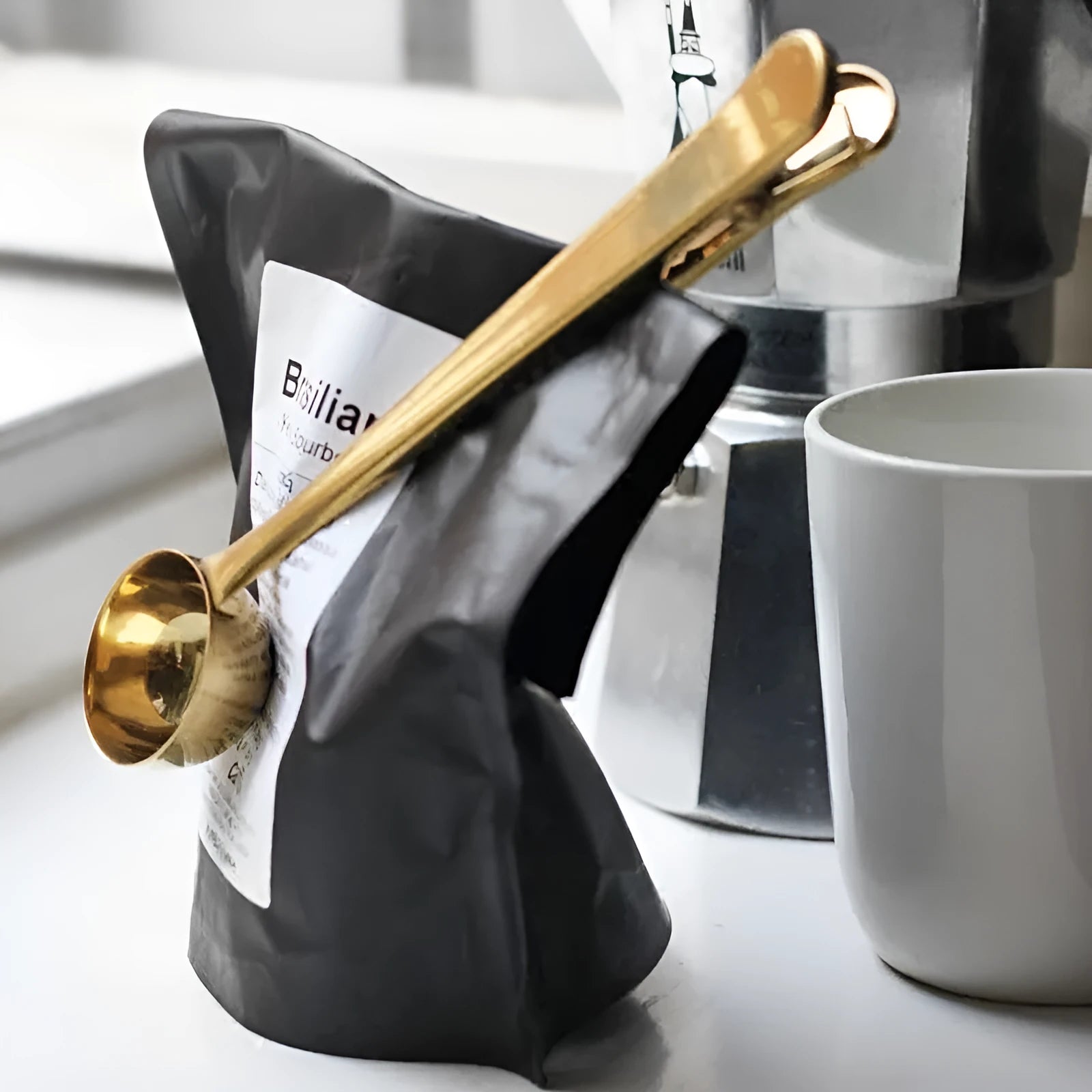 Silver stainless steel coffee clip spoon with measuring scoop and bag clip on a belt clip, 17.5cm long