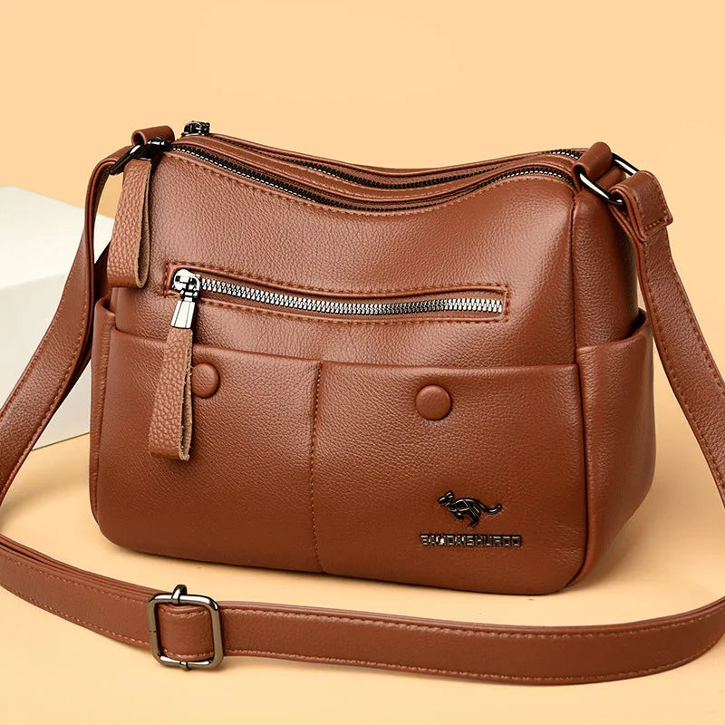 Soft PU leather crossbody bag in horizontal square shape with stitching detail, showing multiple colour options black dark blue wine red yellow.